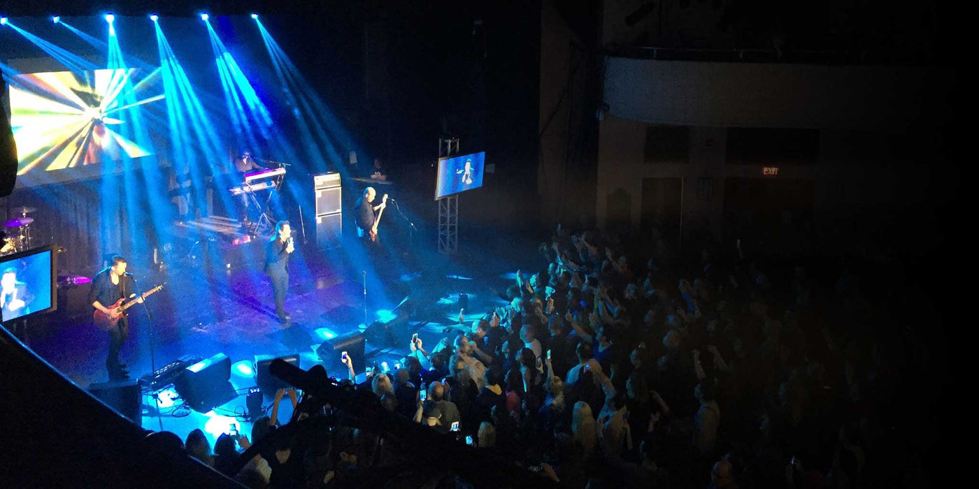 Chevalier Theatre live performance band and crowd with blue lights overhead